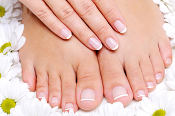 Beauty treatment of a  female feet with camomile's flower around it